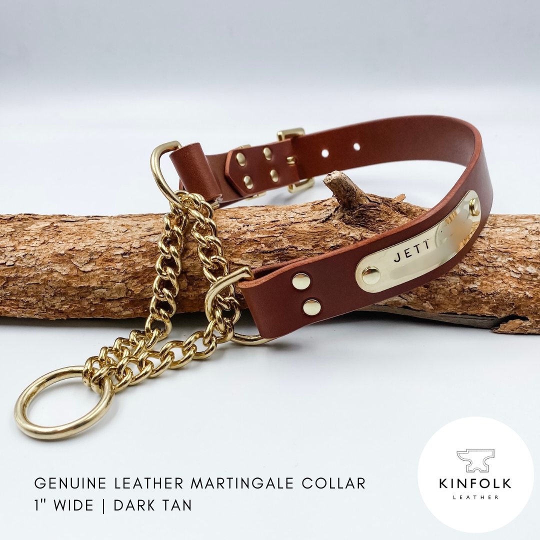 Brown leather martingale collar with gold chain on a wooden branch, featuring the brand 'KINFOLK Leather'.
