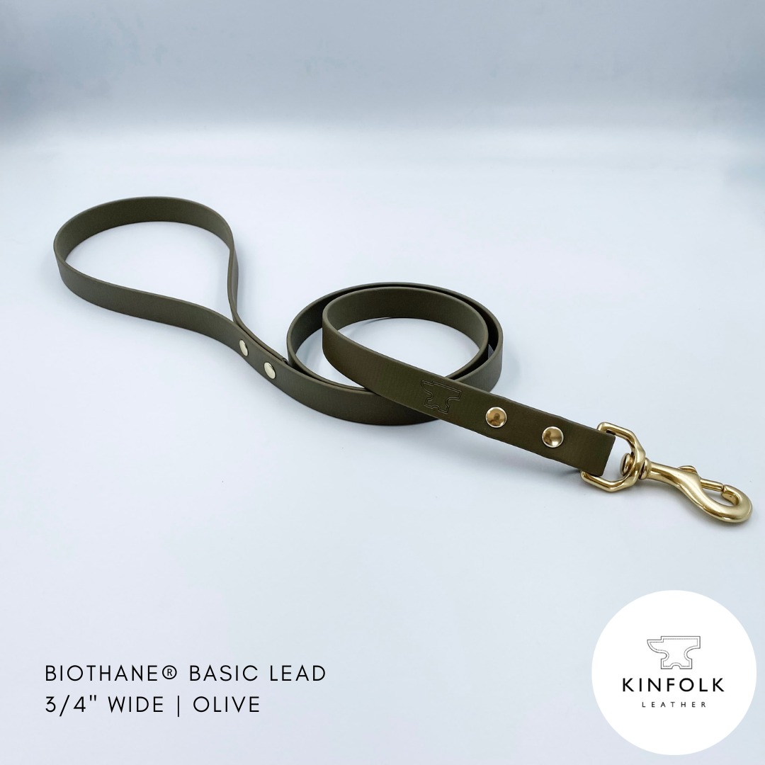 Olive green waterproof biothane dog lead with gold hardware on a light gray background, featuring the Kinfolk Leather logo.