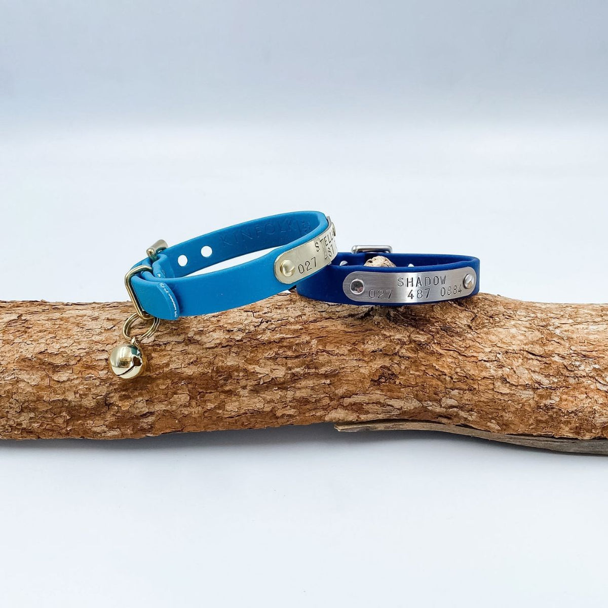 Blue BioThane cat collars with brass hardware and personalised nameplates, handmade in New Zealand.