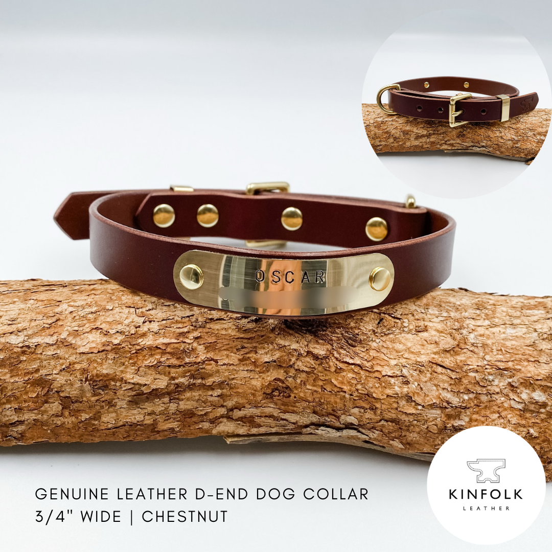 Brown leather dog collar with gold D-end on a wooden branch, featuring the brand 'KINFOLK Leather'.
