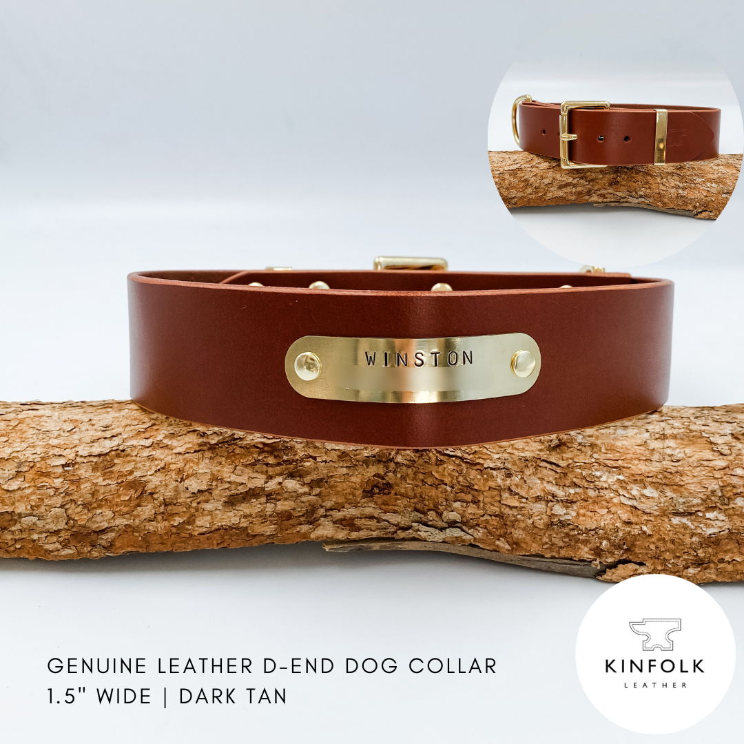 Dark tan leather dog collar with gold buckle and 'Winston' tag on a wooden branch, brand 'Kinfolk Leather' visible.